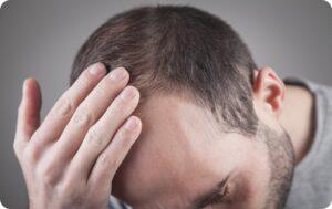 Caucasian man checking his hair. Hair loss problem