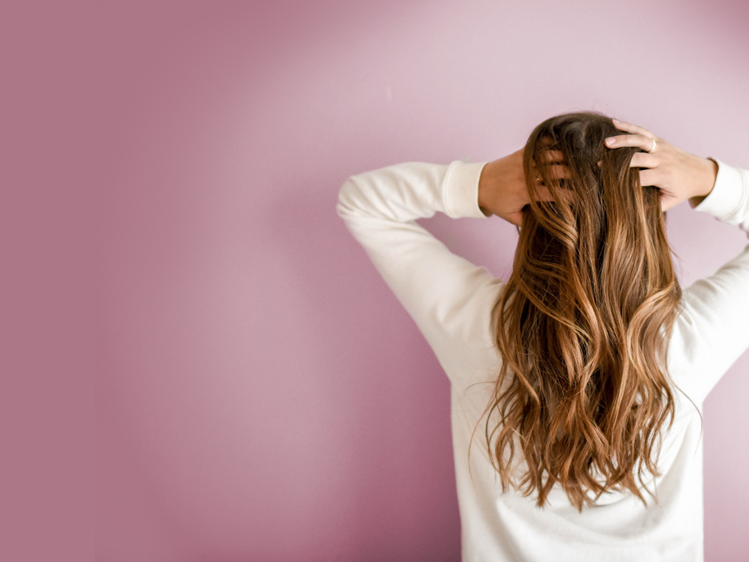 woman-holding-back-of-hair-header-tablet